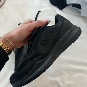 All black Nike running shoes